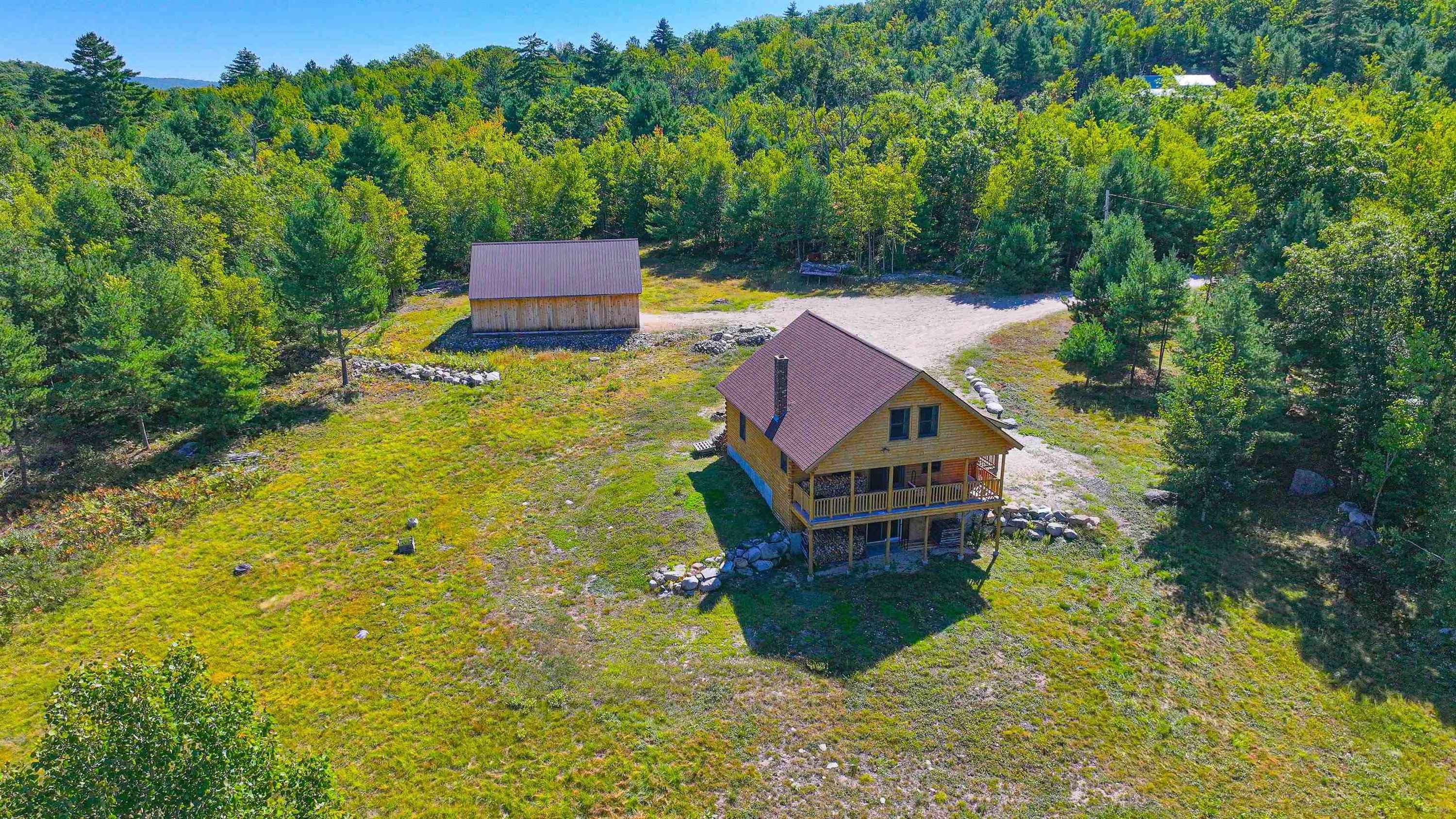Welcome home to Maine's Ward Cedar Log home! The home sits at the top of a private road with plenty 