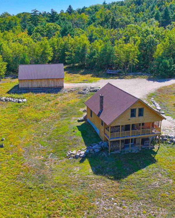 Welcome home to Maine's Ward Cedar Log home! The home sits at the top of a private road with plenty
